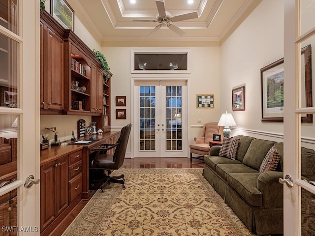 office space with ornamental molding, built in desk, ceiling fan, and french doors