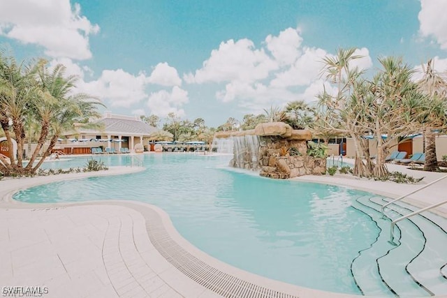 view of swimming pool with pool water feature