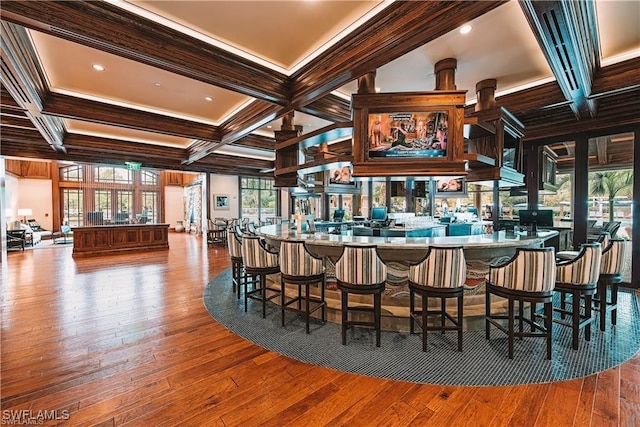 bar featuring crown molding, coffered ceiling, hardwood / wood-style floors, and beam ceiling