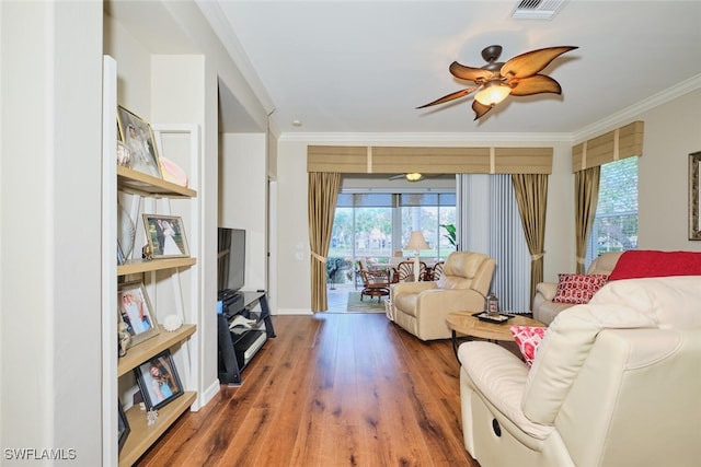 living room with ceiling fan, crown molding, and hardwood / wood-style flooring