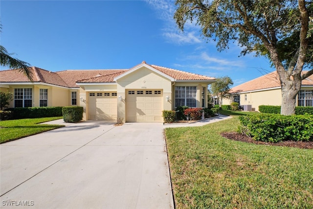 mediterranean / spanish-style home featuring a front lawn and a garage