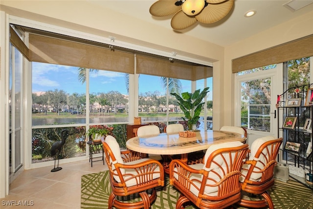 sunroom / solarium with a water view