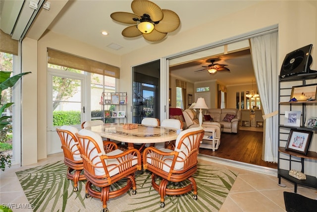 dining area with ceiling fan, ornamental molding, and light tile patterned floors