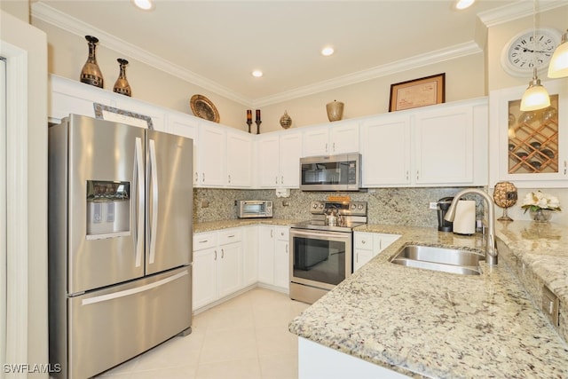 kitchen featuring light stone counters, pendant lighting, stainless steel appliances, decorative backsplash, and sink