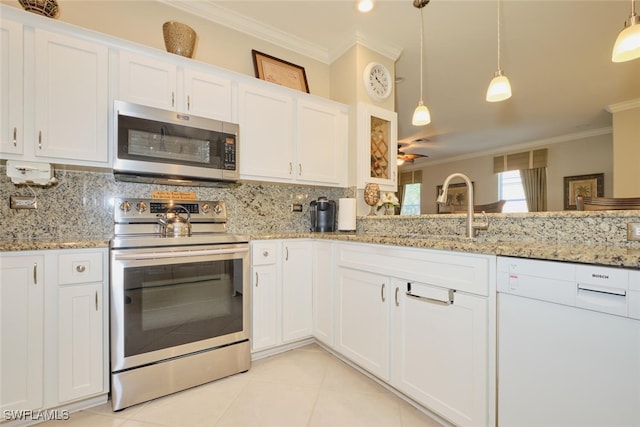 kitchen with decorative light fixtures, stainless steel appliances, decorative backsplash, and white cabinetry