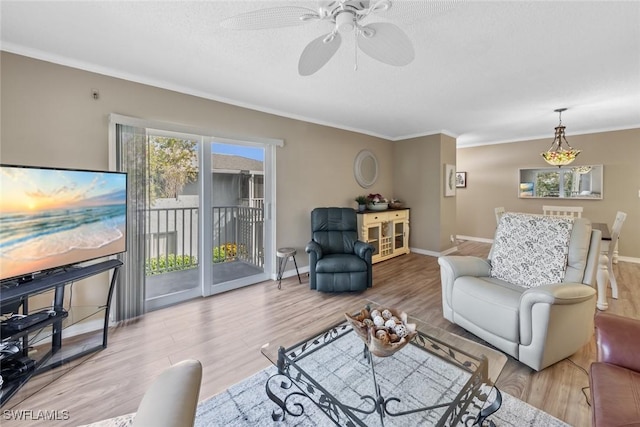 living room featuring light hardwood / wood-style floors, crown molding, and ceiling fan