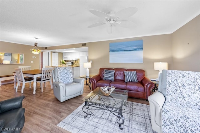 living room with ceiling fan and light hardwood / wood-style floors