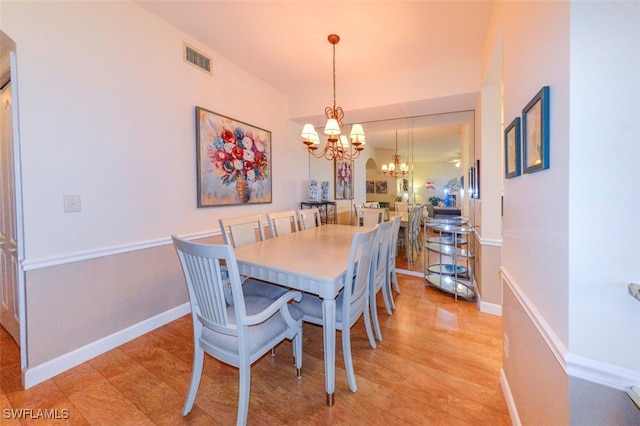 dining area featuring a chandelier and light hardwood / wood-style flooring