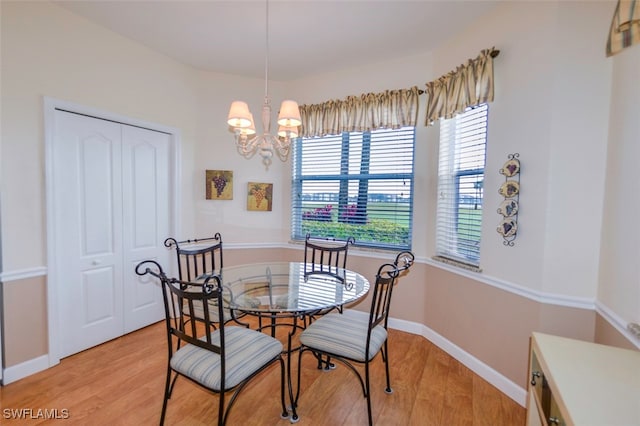 dining room featuring an inviting chandelier and light hardwood / wood-style floors