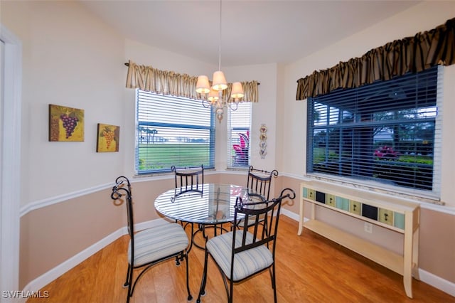 dining room with an inviting chandelier and hardwood / wood-style flooring