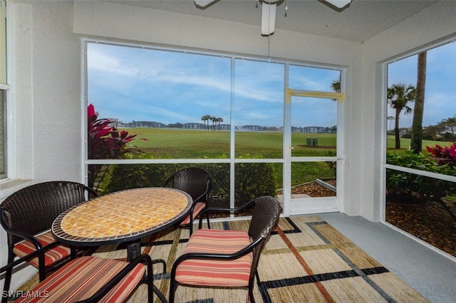 sunroom featuring a healthy amount of sunlight and ceiling fan