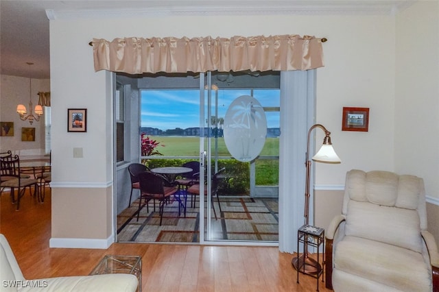 doorway to outside with wood-type flooring and crown molding