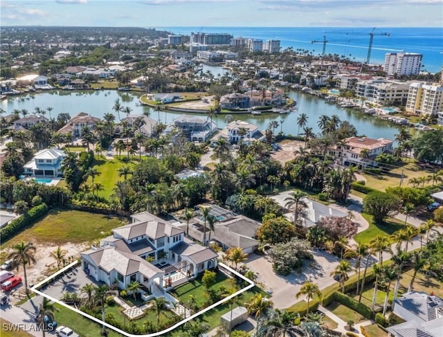 drone / aerial view featuring a residential view, a water view, and a city view