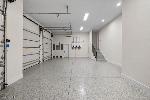 garage with recessed lighting and baseboards