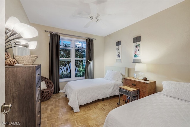 bedroom with ceiling fan and light parquet flooring