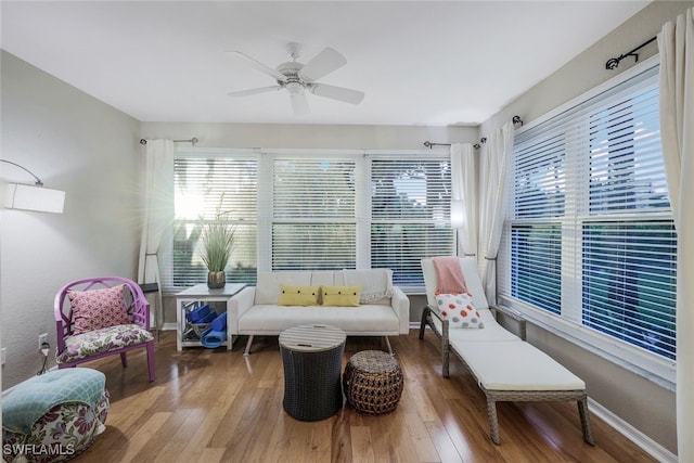 living area featuring hardwood / wood-style flooring and ceiling fan