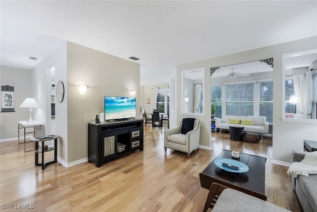 living room with ceiling fan and light hardwood / wood-style floors