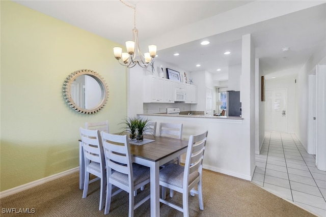 tiled dining room with a chandelier