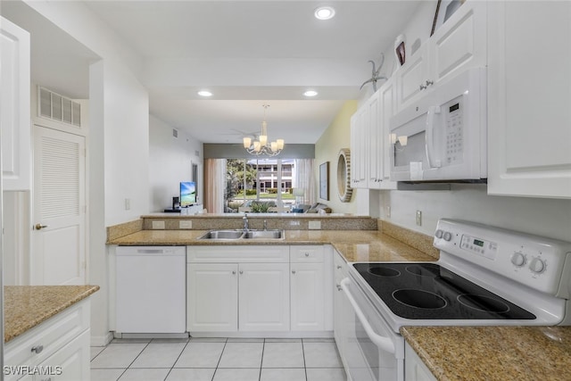 kitchen with white cabinetry, a notable chandelier, white appliances, hanging light fixtures, and sink