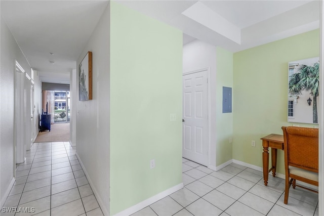 corridor with light tile patterned floors and electric panel