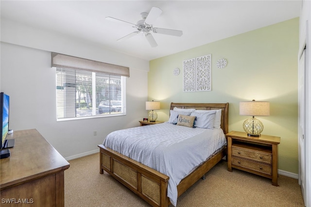 bedroom with ceiling fan and light colored carpet