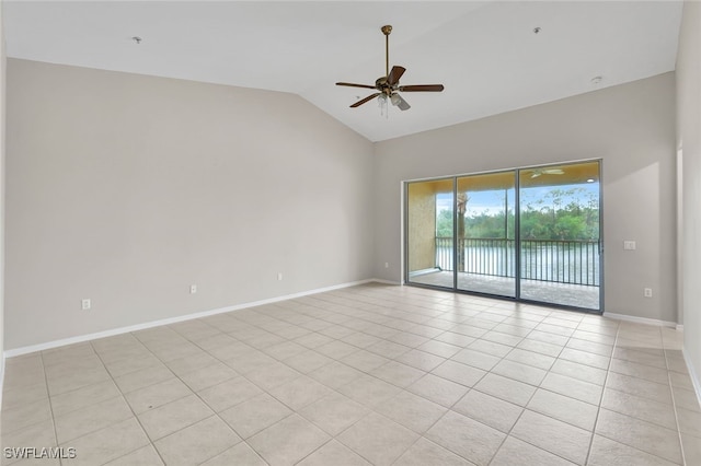 empty room featuring ceiling fan, lofted ceiling, and light tile patterned floors