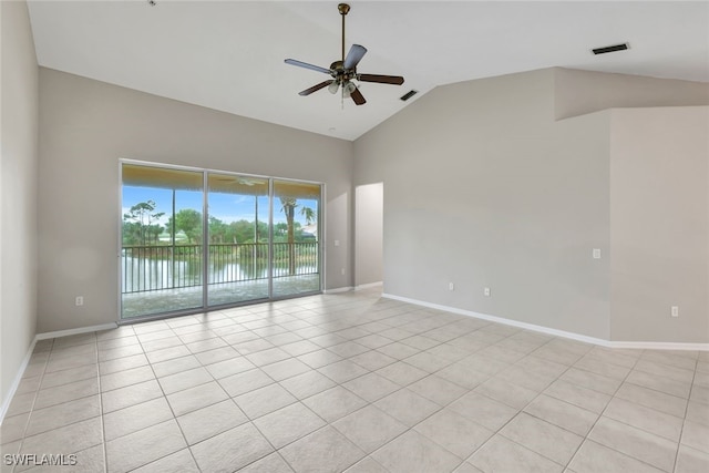 tiled empty room featuring lofted ceiling, ceiling fan, and a water view