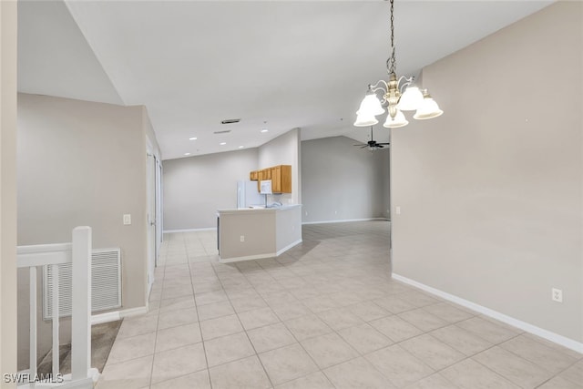 tiled spare room featuring ceiling fan with notable chandelier