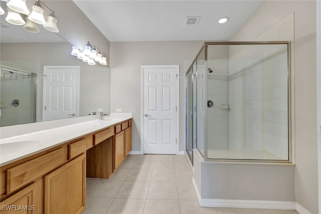 bathroom with walk in shower, vanity, and tile patterned floors