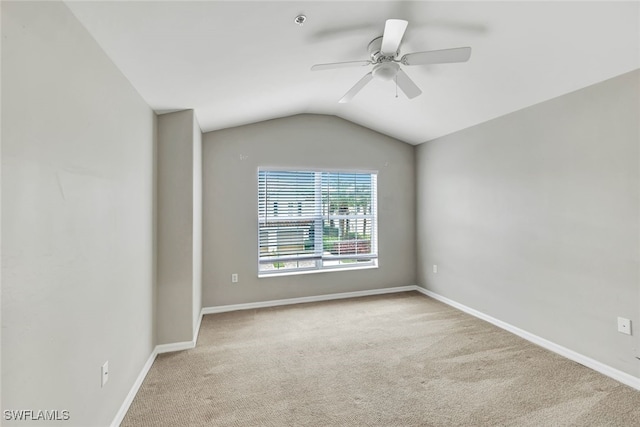 unfurnished room with ceiling fan, vaulted ceiling, and carpet flooring