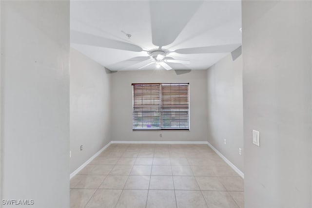 tiled empty room featuring ceiling fan