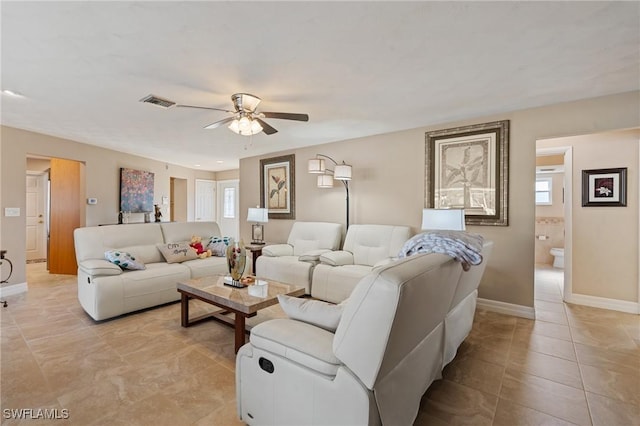 tiled living room featuring ceiling fan