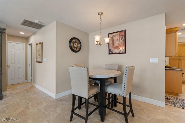 dining space featuring an inviting chandelier