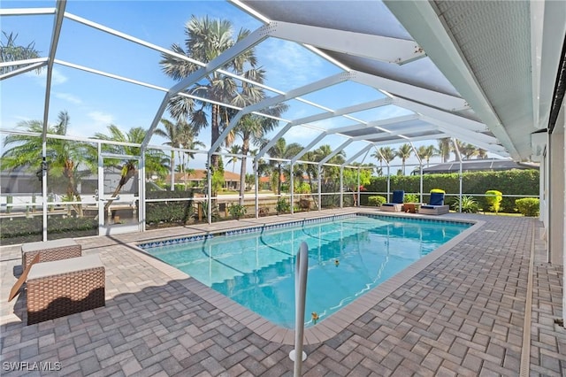 view of swimming pool with glass enclosure and a patio area