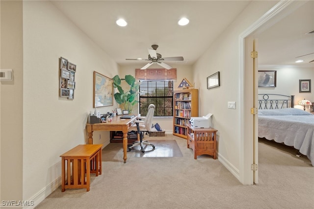 carpeted office space featuring ceiling fan