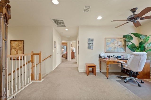 home office featuring light carpet and ceiling fan