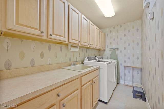 laundry area with cabinets, sink, independent washer and dryer, and light tile patterned flooring