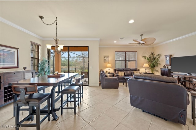 tiled dining room with ornamental molding and ceiling fan with notable chandelier