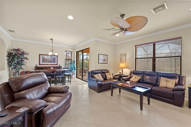 tiled living room featuring ceiling fan with notable chandelier, ornamental molding, and a healthy amount of sunlight