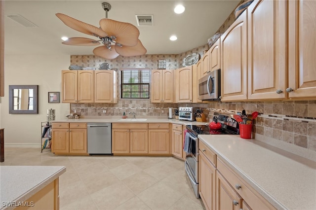 kitchen with ceiling fan, light tile patterned floors, light brown cabinets, and appliances with stainless steel finishes