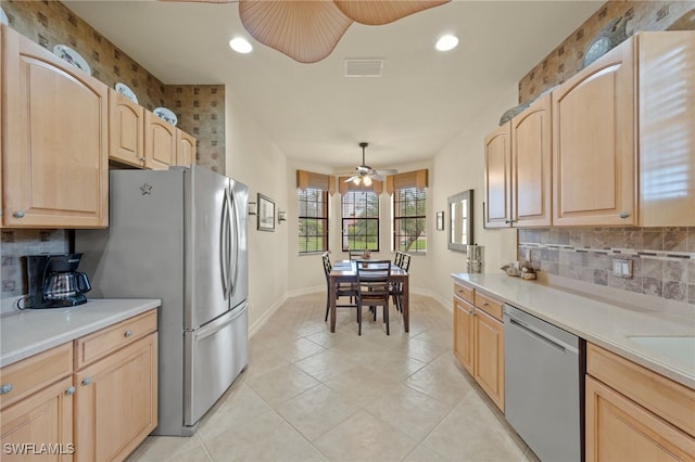 kitchen with ceiling fan, decorative light fixtures, appliances with stainless steel finishes, and light brown cabinets