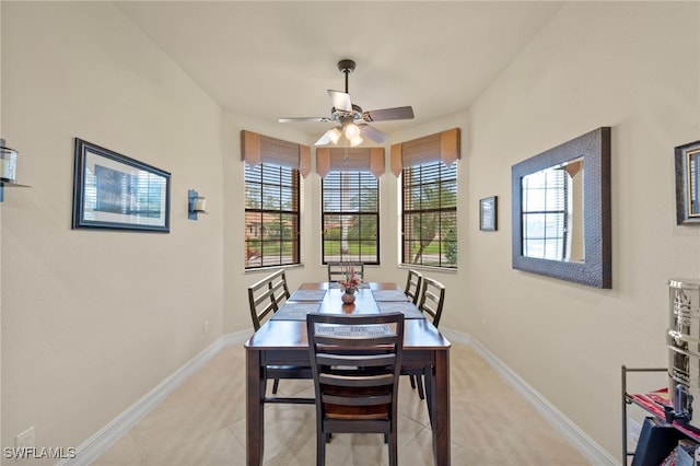 tiled dining room featuring ceiling fan