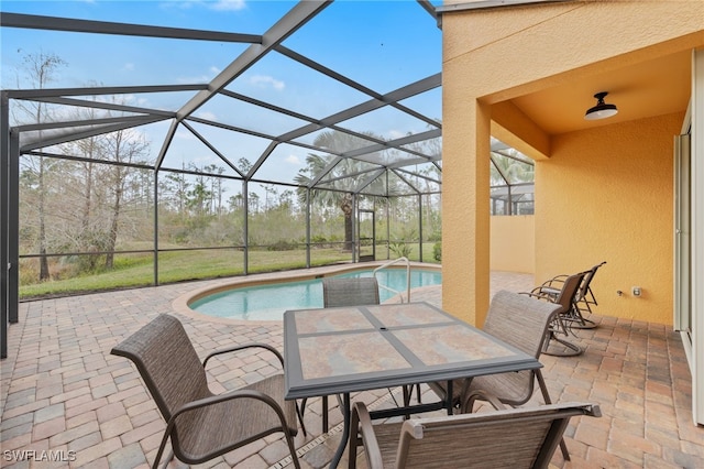 view of swimming pool with a lanai and a patio