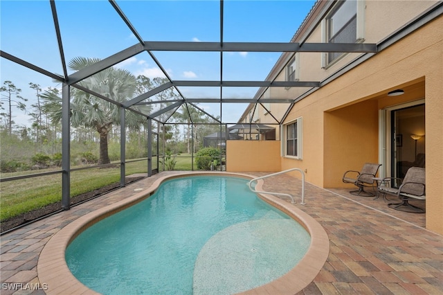 view of swimming pool with a lanai and a patio