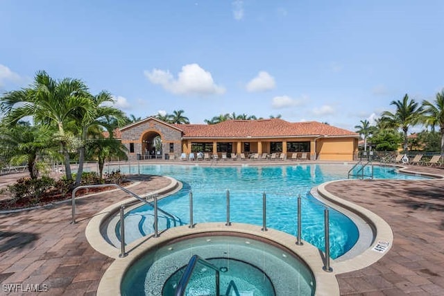 view of pool with a community hot tub and a patio