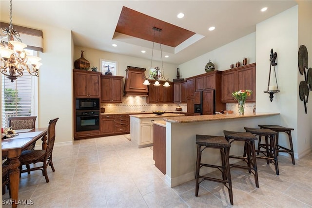 kitchen featuring a tray ceiling, custom exhaust hood, black appliances, and decorative backsplash