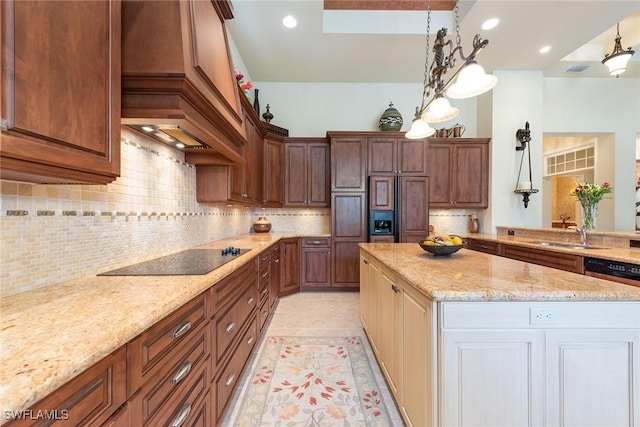 kitchen featuring decorative backsplash, custom range hood, a sink, black electric cooktop, and light stone countertops