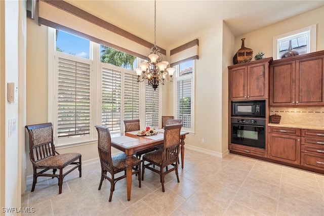 dining area featuring baseboards, a chandelier, and light tile patterned flooring