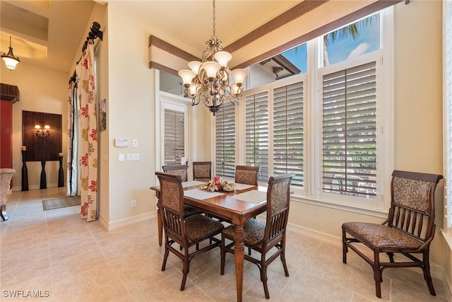 dining area with light tile patterned floors, baseboards, and an inviting chandelier