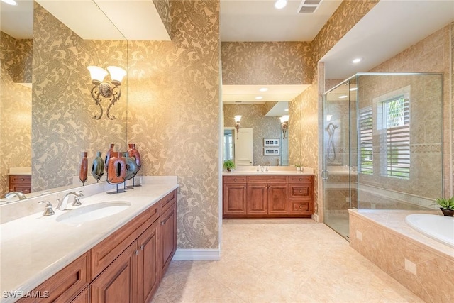 bathroom featuring a shower stall, wallpapered walls, and a sink